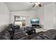 Open living room with modern decor, dark brown leather sofa and sliding glass doors at 105 Winchester Ln, Haines City, FL 33844