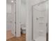 A modern bathroom featuring a toilet, walk-in shower and open door to the walk-in closet at 1107 Olivine Ave, Dundee, FL 33838