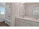 Modern bathroom featuring double sinks, wood-look flooring, and bathtub with shower at 1107 Olivine Ave, Dundee, FL 33838