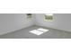 Sunlit carpeted bedroom with white walls and a window allowing natural light at 1107 Olivine Ave, Dundee, FL 33838