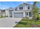 Charming two-story home featuring an attached two-car garage, fresh landscaping, and a welcoming blue front door at 1107 Olivine Ave, Dundee, FL 33838