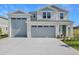 Charming home featuring an attached two-car garage, fresh landscaping, and a welcoming front entrance at 1107 Olivine Ave, Dundee, FL 33838