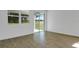 Bright living room with sliding glass doors that bring the outdoors in, paired with stylish wood-look flooring at 1107 Olivine Ave, Dundee, FL 33838