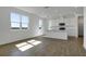 Bright open-concept living and kitchen area, featuring wood-look floors, large windows, and abundant natural light at 1107 Olivine Ave, Dundee, FL 33838
