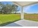 Covered patio offers backyard views, with green grass and blue sky at 1107 Olivine Ave, Dundee, FL 33838