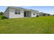 New backyard with green grass and view of the homes in the community at 1122 Olivine Ave, Dundee, FL 33838