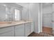 Bathroom with double sinks, quartz countertops, and wood-look tile floors at 1122 Olivine Ave, Dundee, FL 33838