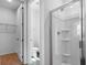 En-suite bathroom with a glass-enclosed shower and walk-in closet at 1122 Olivine Ave, Dundee, FL 33838