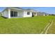 A large backyard with lush green grass and a newly constructed home at 1134 Olivine Ave, Dundee, FL 33838