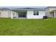 A spacious backyard featuring a newly-built home and lush green grass at 1134 Olivine Ave, Dundee, FL 33838
