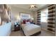 Charming bedroom featuring a ceiling fan, a baseball-themed art print and tasteful striped window coverings at 1134 Olivine Ave, Dundee, FL 33838