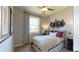 Comfortable bedroom featuring natural light from a large window and unique giraffe artwork above the bed at 1134 Olivine Ave, Dundee, FL 33838