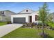 Charming one-story home with a two-car garage, landscaped yard, and white exterior at 1134 Olivine Ave, Dundee, FL 33838
