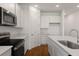Spacious kitchen featuring white cabinets, stainless appliances, and an island with sink at 1134 Olivine Ave, Dundee, FL 33838