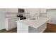 Bright kitchen with a large center island, stainless steel appliances, and modern finishes at 1134 Olivine Ave, Dundee, FL 33838