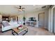 Well-lit living room featuring comfortable seating, a ceiling fan, and view of the kitchen at 1134 Olivine Ave, Dundee, FL 33838