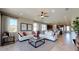 Bright and airy living room featuring comfortable seating, a ceiling fan, and large windows at 1134 Olivine Ave, Dundee, FL 33838