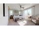 Bright main bedroom with elegant tufted headboard, modern furnishings, and plenty of natural light at 1134 Olivine Ave, Dundee, FL 33838