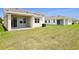View of the backyard showing lawn and exterior of homes in the neighborhood at 1138 Olivine Ave, Dundee, FL 33838