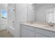 Bathroom with double sink vanity, mirror, shower/bath, and window view at 1138 Olivine Ave, Dundee, FL 33838