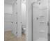 Bright bathroom featuring a glass-enclosed shower with tiled flooring and toilet at 1138 Olivine Ave, Dundee, FL 33838