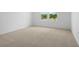 Neutral bedroom showing the carpeting, base trim, and the window at 1138 Olivine Ave, Dundee, FL 33838