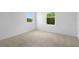 Bedroom featuring carpeting, dual windows, and electric outlet at 1138 Olivine Ave, Dundee, FL 33838