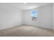 Simple bedroom with carpeting, one window and electric outlet at 1138 Olivine Ave, Dundee, FL 33838