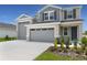 Stylish two-story home featuring a three car garage and beautifully landscaped front yard at 1138 Olivine Ave, Dundee, FL 33838