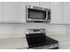Modern kitchen featuring stainless steel appliances and beautiful quartz countertops at 1138 Olivine Ave, Dundee, FL 33838