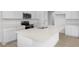 Bright kitchen featuring white cabinets, quartz countertops, and a stainless steel microwave at 1138 Olivine Ave, Dundee, FL 33838