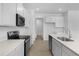 Bright kitchen featuring white cabinets, stainless steel appliances, and tile flooring at 1138 Olivine Ave, Dundee, FL 33838