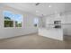 Bright open-concept room with tile flooring, large windows, and a breakfast bar at 1138 Olivine Ave, Dundee, FL 33838