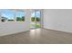 Bright open-concept room with tile flooring and sliding glass door at 1138 Olivine Ave, Dundee, FL 33838