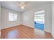 Bright bedroom with hardwood floors and sliding door leading to enclosed, carpeted sun room at 1211 Shawnee Dr, Kissimmee, FL 34744