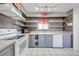 Bright kitchen featuring white appliances, grey cabinets, and open shelving for easy storage and display at 1211 Shawnee Dr, Kissimmee, FL 34744