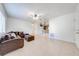 Inviting living room with a ceiling fan, neutral tile flooring, and an open view to the kitchen at 1211 Shawnee Dr, Kissimmee, FL 34744