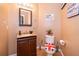A quaint, decoratively appointed powder room with marble countertop sink and unique design elements at 133 Rona Ln, Davenport, FL 33897