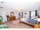 Spacious bedroom featuring natural light, carpeted floors, a ceiling fan, and neutral decor at 133 Rona Ln, Davenport, FL 33897