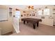 Upstairs bonus room featuring a pool table, carpet floors, ceiling fan, and decorative wall decor at 133 Rona Ln, Davenport, FL 33897