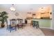 Bright dining area featuring tile flooring, a dining table set, and an adjacent breakfast bar with seating at 133 Rona Ln, Davenport, FL 33897