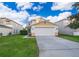 Charming two-story home featuring a two-car garage, neat landscaping, and a welcoming driveway at 133 Rona Ln, Davenport, FL 33897