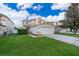 Two-story home with attached two-car garage and a well-manicured lawn in a suburban neighborhood at 133 Rona Ln, Davenport, FL 33897