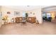 Cozy living room featuring a sectional sofa, glass tables, and view into the adjacent dining area at 133 Rona Ln, Davenport, FL 33897