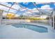 Screened in in-ground pool with a white painted deck and metal enclosure at 133 Rona Ln, Davenport, FL 33897