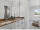 Bright bathroom with a double sink vanity, marble countertop, and a view to the bedroom at 1436 Stetson St, Orlando, FL 32804