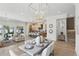 Bright open-concept dining area with modern chandelier, leading to gourmet kitchen and comfortable living room at 1436 Stetson St, Orlando, FL 32804