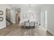 Elegant dining room with modern chandelier, hardwood floors, neutral walls, and lots of natural light at 1436 Stetson St, Orlando, FL 32804