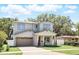 Charming two-story home featuring a brick driveway, attached garage, and well-manicured landscaping with green grass at 1436 Stetson St, Orlando, FL 32804