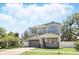 Charming two-story home featuring a brick driveway, attached garage, and well-manicured landscaping with green grass at 1436 Stetson St, Orlando, FL 32804